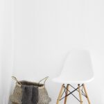 white and brown chairs beside wicker basket near white wall